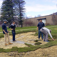 students laying golf turf on the test course