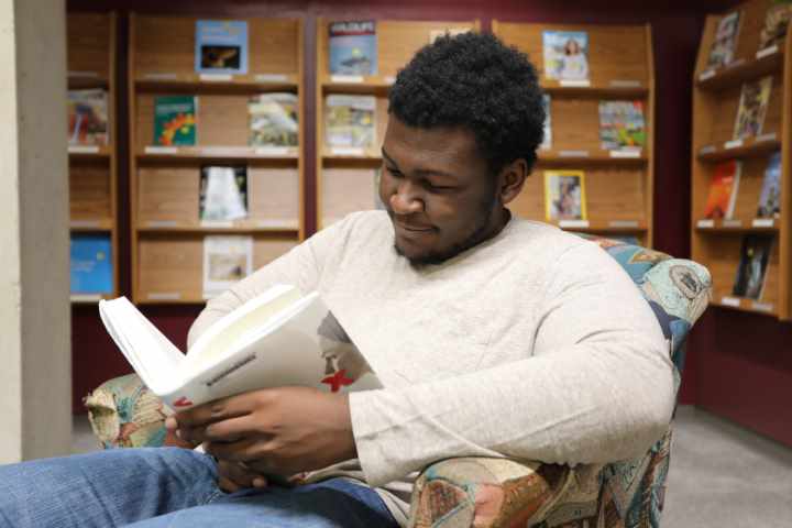 Student sitting and reading a book